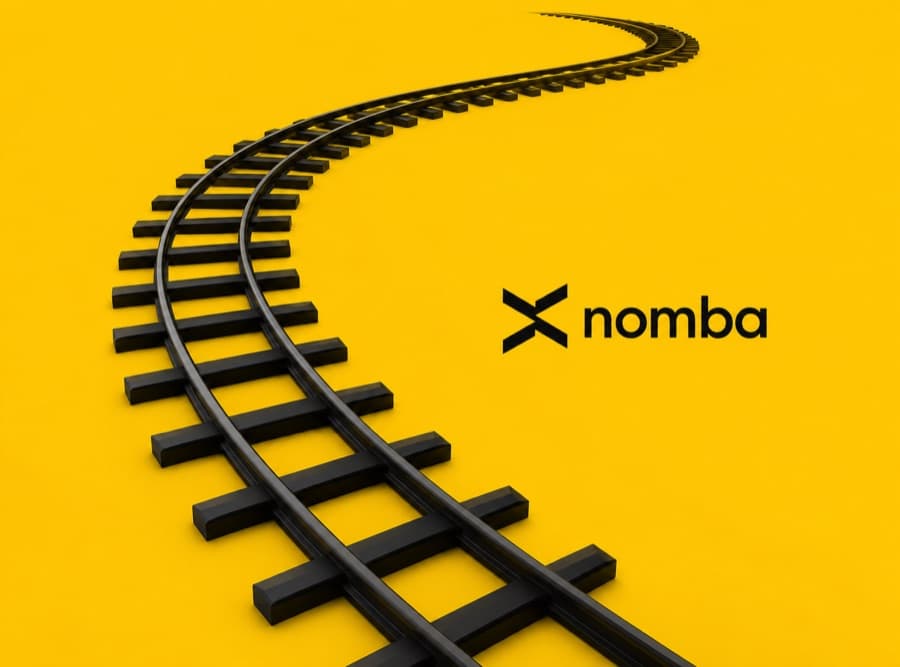 Railway tracks curving forward beside the Nomba logo
